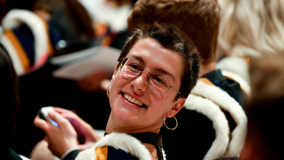 Student smiling during an RCM graduation ceremony